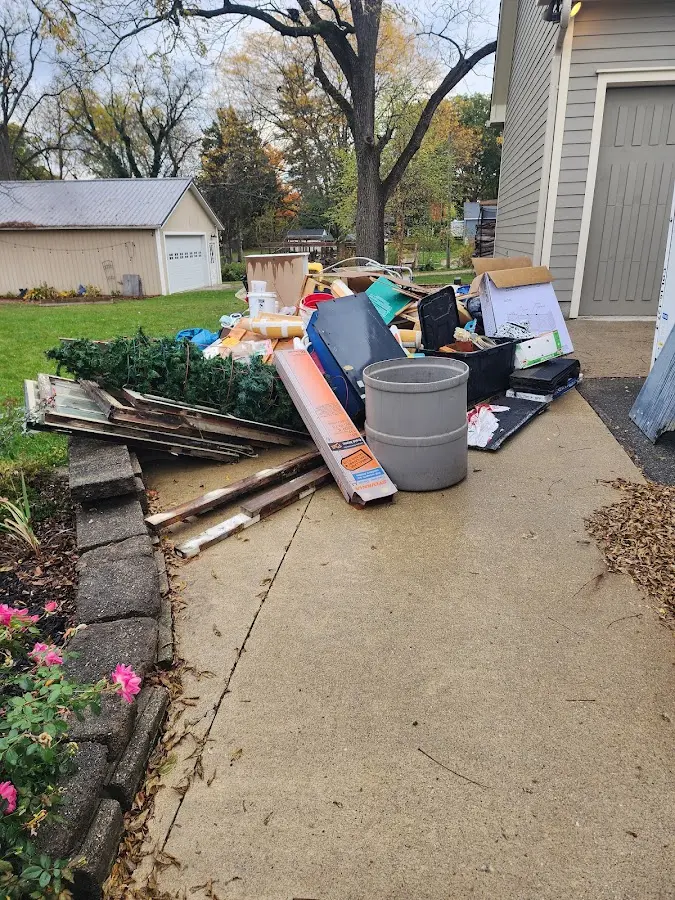 Dumpster being loaded with debris for Roofing Dumpster Rental in Marshfield